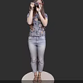 Woman Taking Photo With Camera On White Round Platform Wearing Floral Top Jeans Black Background
