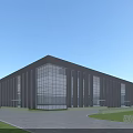 Modern Industrial Factory Building With Glass Curtain Walls Gray Exterior Lawn Area And Paved Road