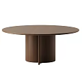 Modern Decorative Ornament Set Arranged On Brown Round Wooden Table For Home Decor