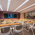 School Classroom Interior With Bright Lighting Wooden Desks Chairs Blackboard And Bookshelves
