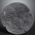 Ancient Circular Stone Relief Sculpture With Detailed Human Head Profile And Artistic Design