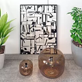 Brown Glass Decorative Lamps With Green Plants And Geometric Art In Living Room