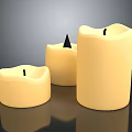 Set Of Three Cream Colored Household Candles With Various Shapes And Wicks