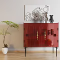 Red Sideboard With Geometric Design And Sculpture Artwork Near Green Plant