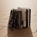 Neatly Stacked Books and Magazines on Wooden Floor with Varied Covers
