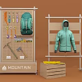 DP Display Unit For Mountain Outdoor Gear With Backpack Jacket And Tools On Wooden Shelf