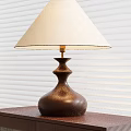 Elegant Table Lamp With White Lampshade And Brown Vase Shaped Base Against Window Blinds