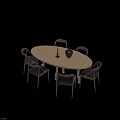 Minimalist Oval Light Wood Dining Table With Dark Brown Chairs And Black Vase
