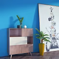 Wooden Console Table with Green Plants and Decorative Painting Against Blue Wall