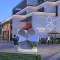 Modern Commercial Street With Multi Story Building Storefronts And Pedestrians Walking