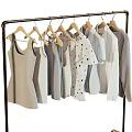 Light Colored Clothes Hanging on Metal Rack with Tank Tops Dresses and T-shirts