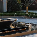 Modern Garden Decor With Outdoor Fountain Green Shrubs And Golden Letter M