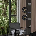 Black Leather Armchair with Gray Blanket near Large Window Golden Pendant Lights and Green Trees