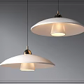 Modern Pendant Lights With White Shades And Brass Accents Illuminated Against Gray Wall