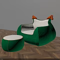 Green Armchair With White Cushion Orange Armrests And Matching Ottoman On Herringbone Wooden Floor