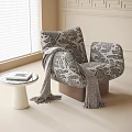 Accent Chair With Animal Print Pattern Throw Blanket And Side Table In Bright Room