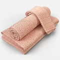 Soft Textured Pink Cotton Towels with Different Sizes Stacked in Bathroom Set