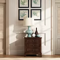 Dark Wooden Nightstand With Light Blue Lamp Small Clock And Decorative Bottle On White Wall