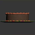 Delicious Chocolate Cake With Red Frosting Border On Colorful Polka Dot Plate