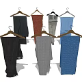 Stylish Assorted Color Pants Hanging On Wooden Hangers With Different Textures And Casual Styles