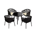 Black Round Table With Four Rattan Chairs And Light Colored Cushions Set