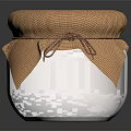 Ceramic Jar With Yellow Preserve And Cloth Lid Tied On Black Background