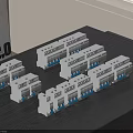 White Multiple Switch Panels Placed On Dark Wooden Table With Gray Wall Background