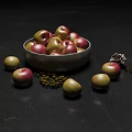 Ripe Red and Green Apples in Metal Bowl with Scattered Fruits on Black Background