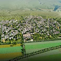 Aerial View Of Rural Village Surrounded By Green Fields And Mountains