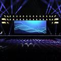 Concert Stage With Blue Lighting Large LED Screen And Audience Seats