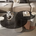 Elegant Black Glass Coffee Table With Cylindrical Legs And Decorative Glassware