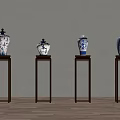 Blue and White Ceramic Vases with Traditional Patterns on Dark Wooden Stands Against Light Wall