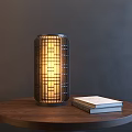 Modern Lattice Design Table Lamp With Warm Light On Wooden Round Table And Books