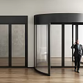 Businessman In Suit Talking On Phone By Revolving Door And Double Doors