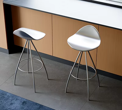 Two Modern Bar Stools With White Seats And Metal Legs In Kitchen With Wooden Cabinets And White Countertop 3d model