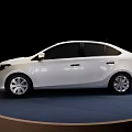 Elegant White Toyota Sedan Showcased On Round Blue Display Platform