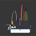 Microcontroller Development Board With Multiple Colored LED Lights And Connecting Wires