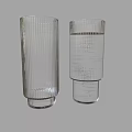 Transparent Glass Cups with Vertical Stripe Design One Empty and One Filled with Water
