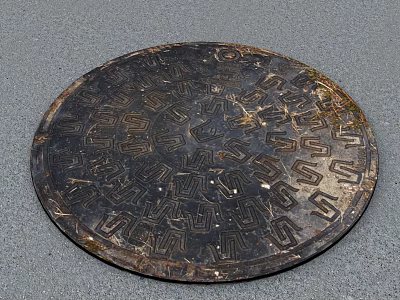 Road Facility Circular Metal Manhole Cover With Intricate Patterns On Pavement 3d model