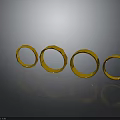 Four Shiny Gold Rings Arranged On Black Background With Reflections