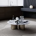 Round Marble Coffee Table With Wine Bottles Glasses Dark Cabinets And Woven Rug Decor