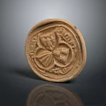 Ancient Clay Seal With Intricate Carvings And Textured Surface Design