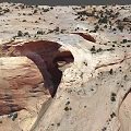 Natural Red Sandstone Rock Arch With Surrounding Desert Vegetation And Landscape