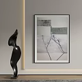 Abstract Black Sculpture Art On Gray Wall With Framed Painting And Soft Lighting
