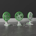 Three Green And White Tabletop Air Conditioner Fans With Stands On Wooden Floor
