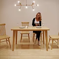 Wooden Dining Table Set With Four Chairs Hanging Light And Tableware In Dining Room