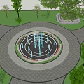 Beautiful Circular Fountain With Blue Water Jets Surrounded By Grass Trees And Flower Beds
