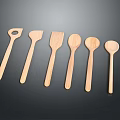 Six Wooden Spoons With Various Shapes Arranged On Dark Background For Kitchen Use