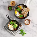 Fresh Fried Eggs With Vegetables And Herbs Served In Cast Iron Pans With Bread Slices