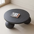 Modern Round Black Coffee Table With Ball Shaped Legs And Books On Top
